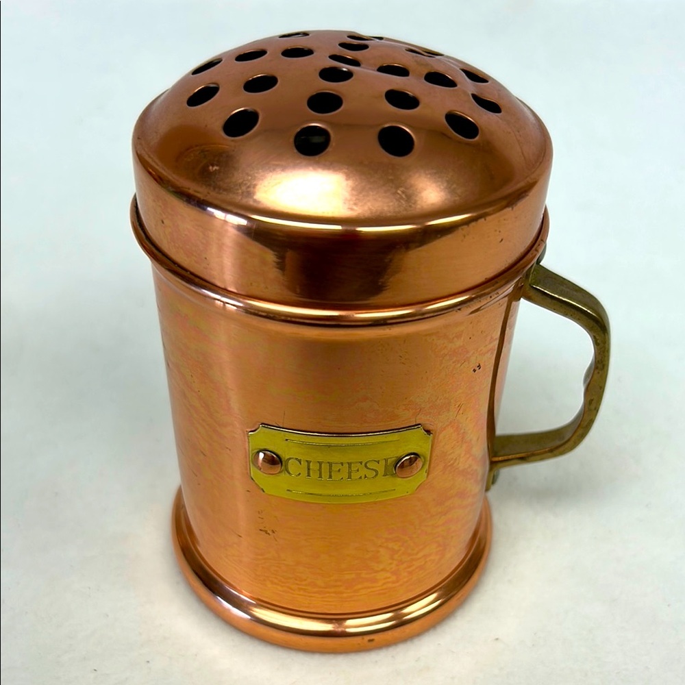 Vintage copper cheese shaker with brass label and handle